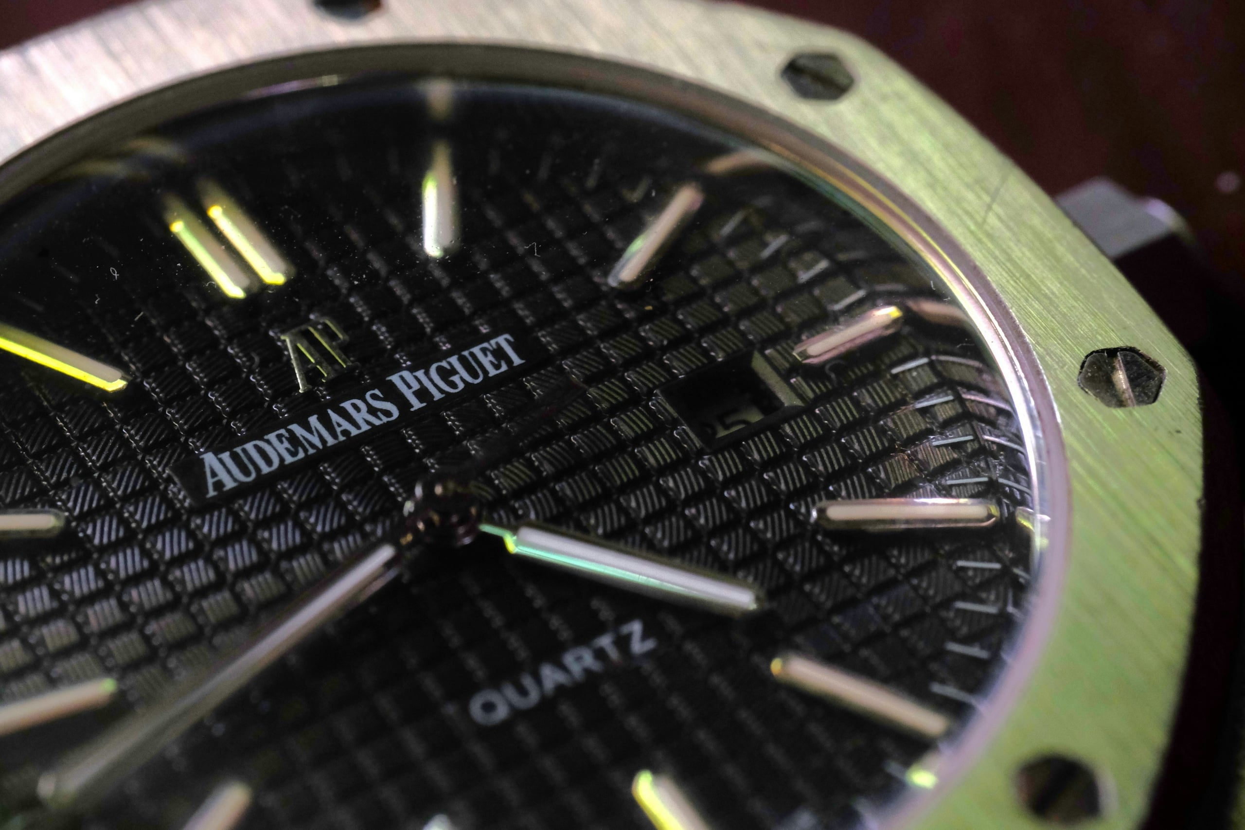 Close-up of a black Tapisserie dial with applied white-gold indices