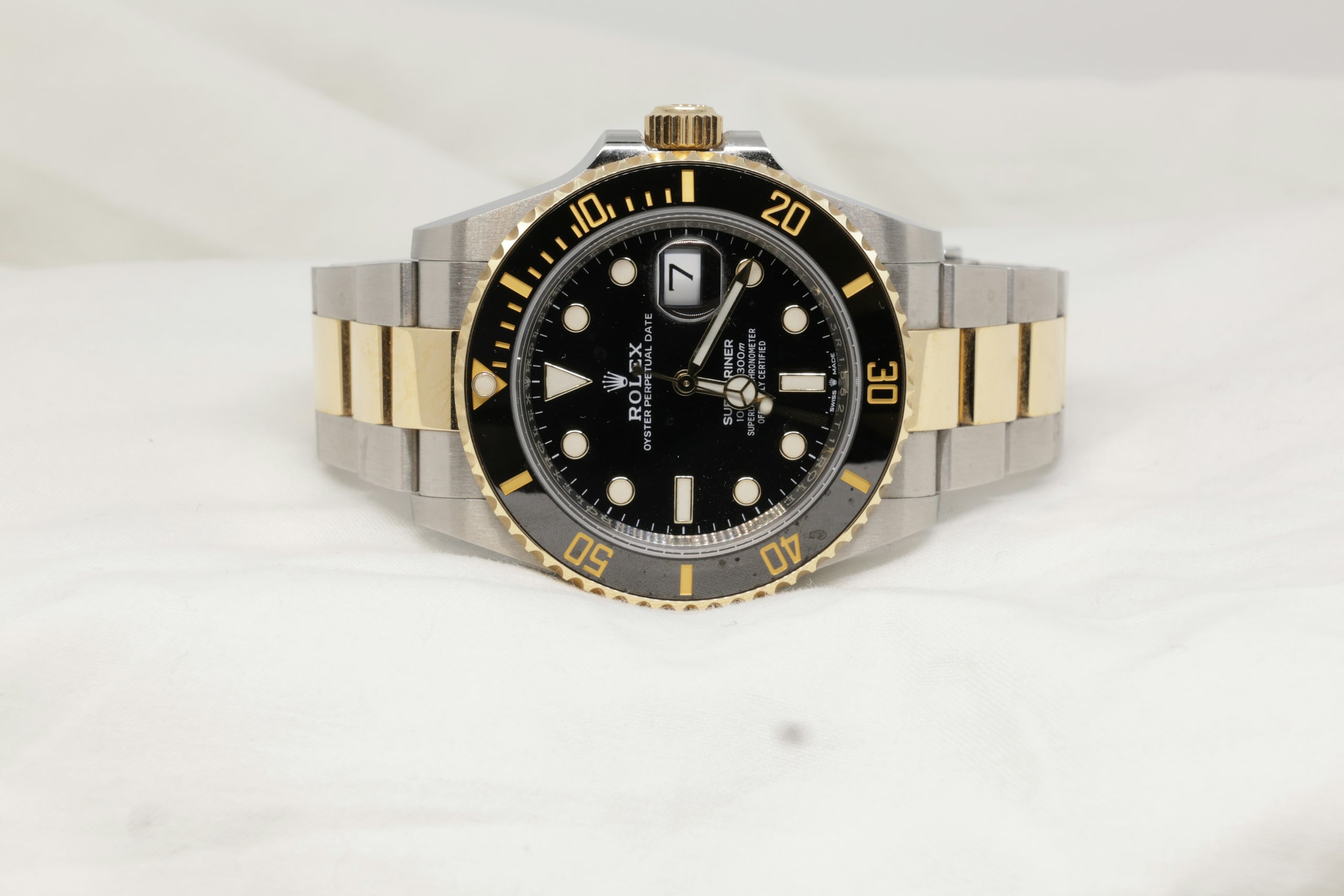 Rolex Submariner Date in steel and yellow gold with black dial and bezel on white linen